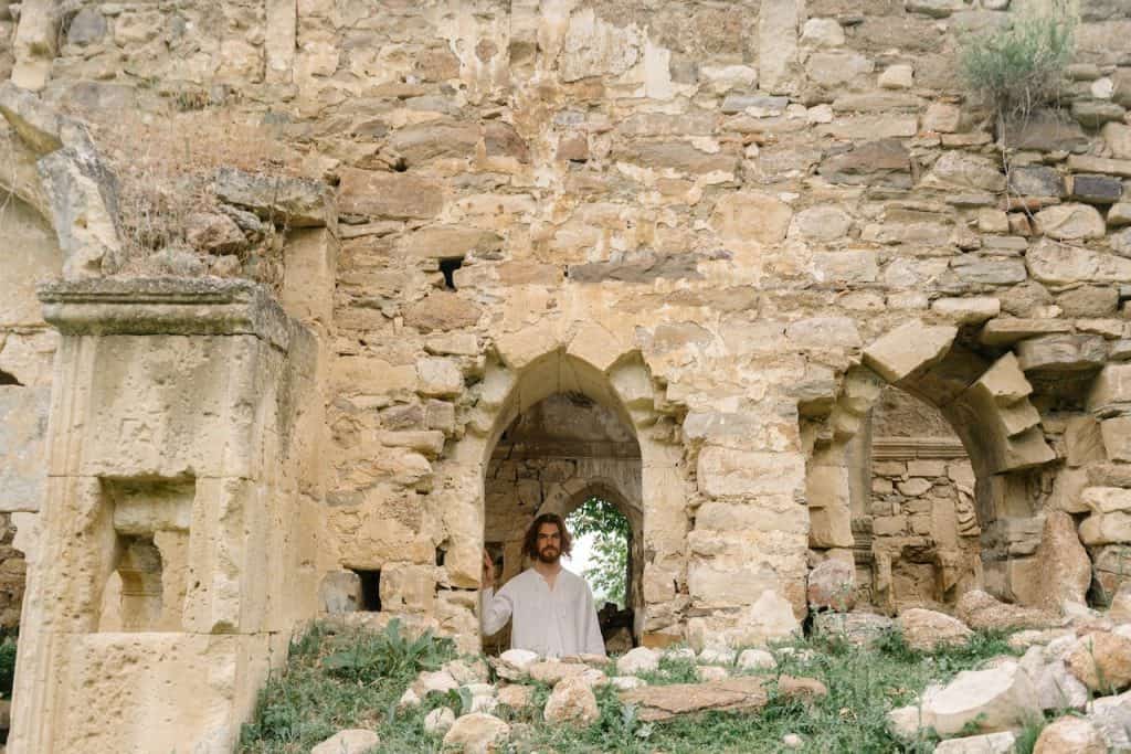 Jesus Christ looking out through a window arch.