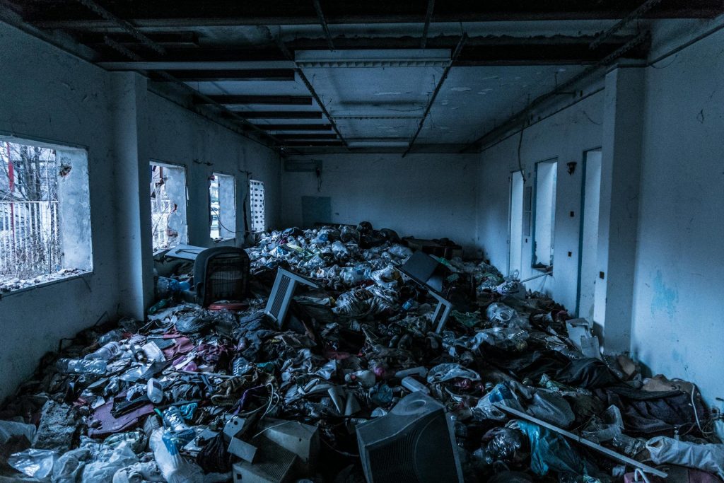 A room filled with garbage, dirt, and other dangerous things, representing the end of the parable.