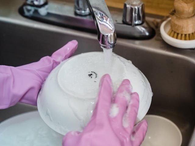 Woman keeping up on keeping her dishes clean, following Biblical foundations of cleanliness